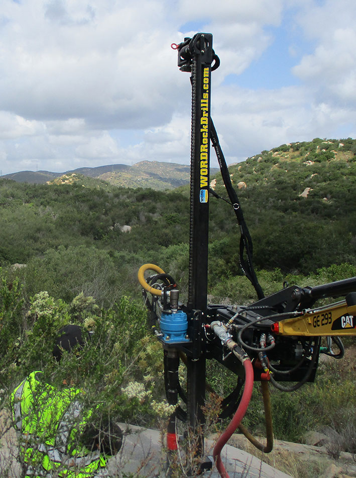 WORD Excavator Attachment drilling holes for the anchoring of a microwave tower