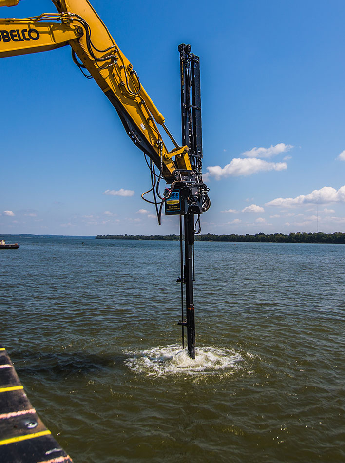 WORD Excavator Attachment being used for underwater lock and dam destruction in Olmstead Illinois.