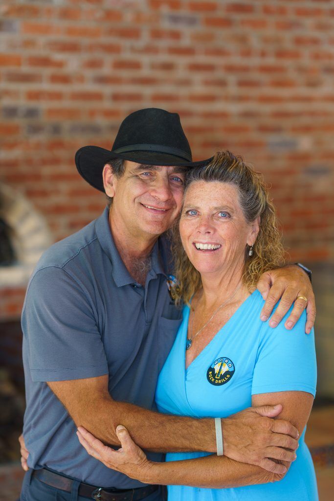 WORD Rock Drills founders John and Lisa Patterson smiling and embracing.